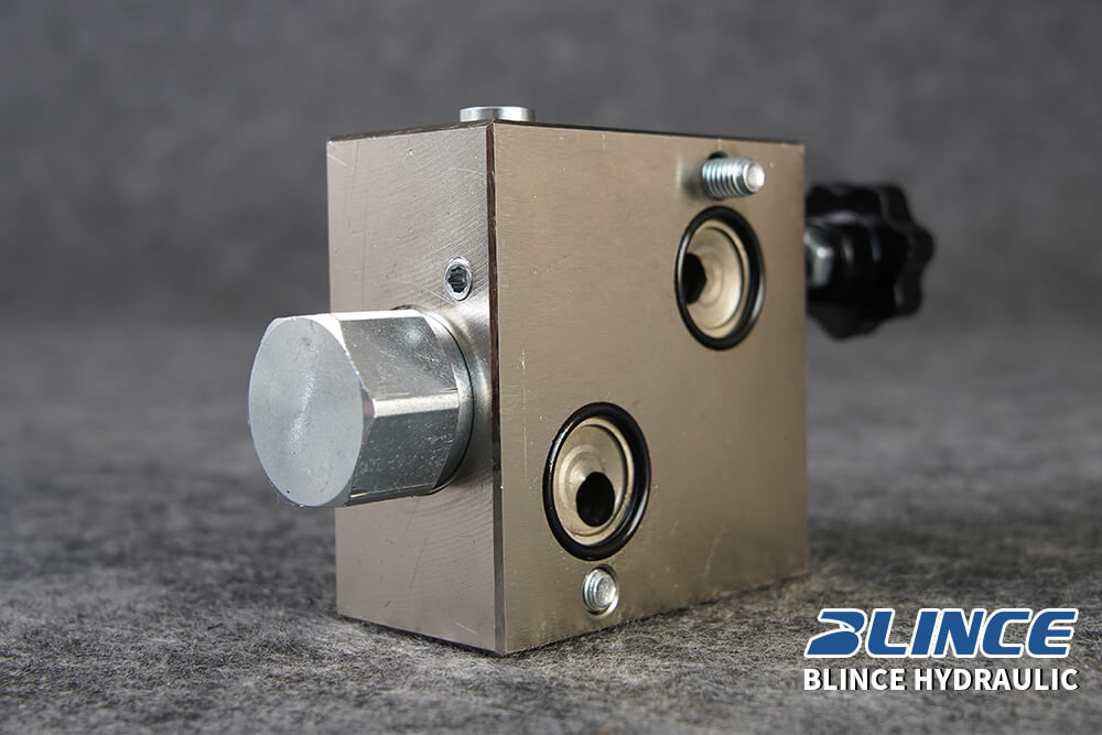 adjustable hydraulic flow control valve body showing metering ports and control knob