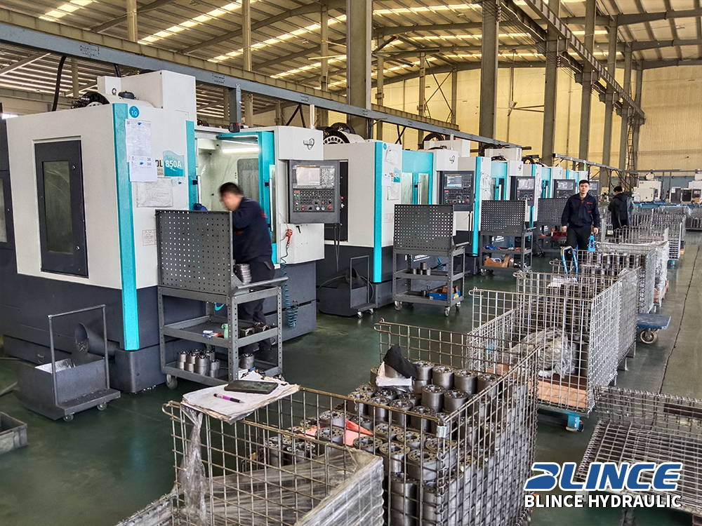 Hydraulic motor and pump components arranged in a factory workshop for precision machining and quality production