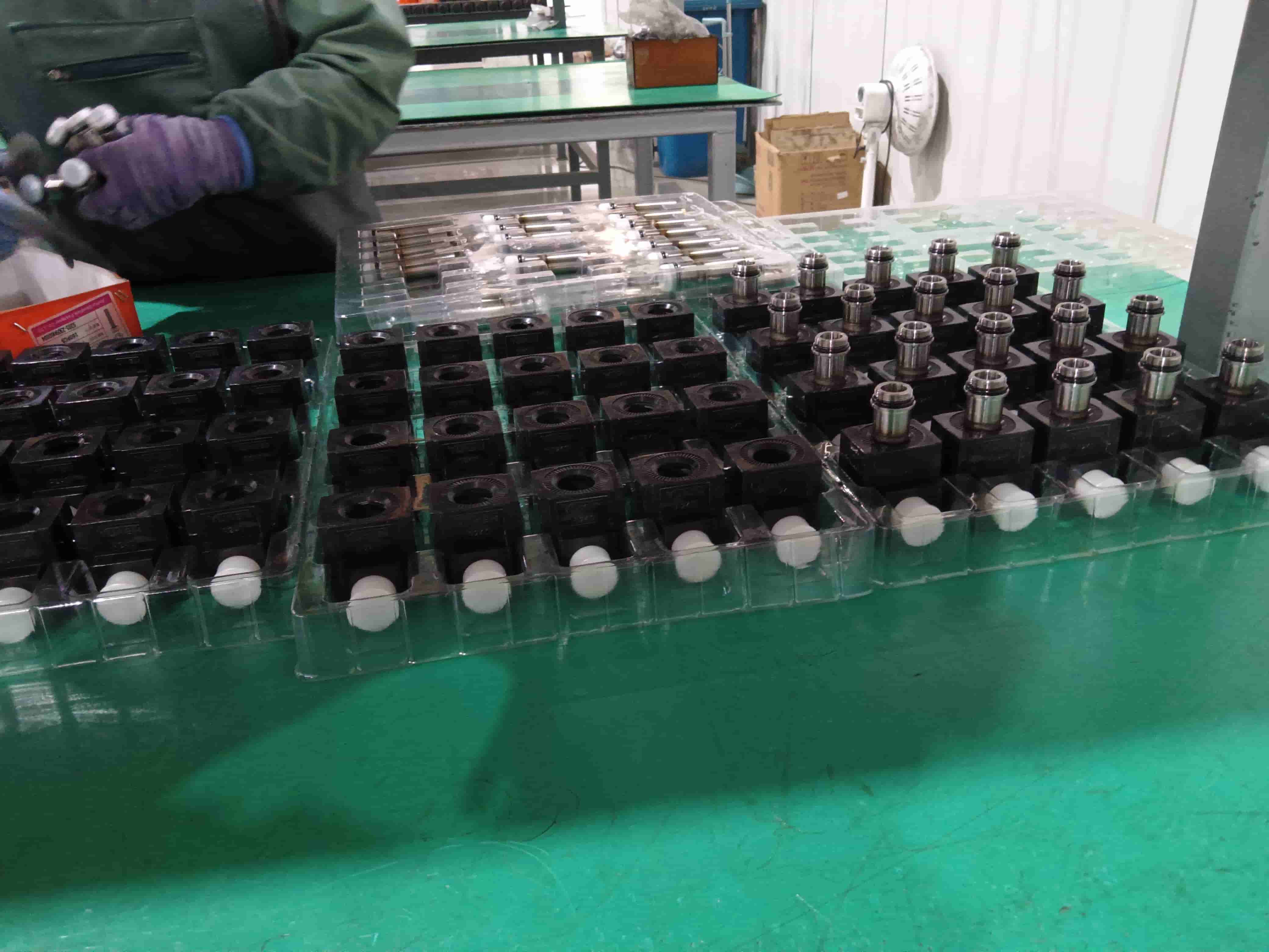 Blince hydraulic valve components and solenoid coils prepared for assembly